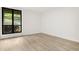 Bedroom features modern light vinyl floors, white walls and large black-framed window at 683 Highland Ct, Marietta, GA 30068