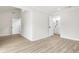 Spacious bedroom features modern light vinyl floors, white walls, and a bathroom at 683 Highland Ct, Marietta, GA 30068