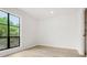 Bright bedroom with neutral walls, hardwood flooring, and a large grid window overlooking yard at 683 Highland Ct, Marietta, GA 30068