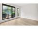 Bedroom features modern light vinyl floors, white walls, black-framed window, and door at 683 Highland Ct, Marietta, GA 30068