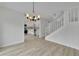 Bright dining area with modern chandelier, and an open view to the updated kitchen and staircase at 683 Highland Ct, Marietta, GA 30068