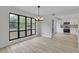 Open dining area with a modern chandelier and a view of the updated kitchen with white cabinets at 683 Highland Ct, Marietta, GA 30068
