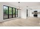 Open dining room with a view of the kitchen, a modern chandelier, and an oversized grid window at 683 Highland Ct, Marietta, GA 30068