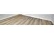 Close up of light colored, hard surface flooring with base trim against white wall at 683 Highland Ct, Marietta, GA 30068