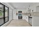 Modern, bright kitchen featuring white cabinets, stainless steel appliances, and quartz countertops at 683 Highland Ct, Marietta, GA 30068