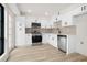 Charming kitchen featuring stainless steel appliances and ample white cabinetry with sleek black hardware at 683 Highland Ct, Marietta, GA 30068