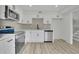 Modern kitchen features white cabinets, stainless steel appliances, and vinyl plank flooring at 683 Highland Ct, Marietta, GA 30068