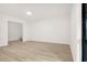 Living room features modern light vinyl floors, white walls and black-framed window at 683 Highland Ct, Marietta, GA 30068