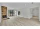 Spacious living room with a stone fireplace, updated flooring, and access to outdoor living at 683 Highland Ct, Marietta, GA 30068