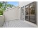 Covered patio with painted wood floor and entry door, adjacent to the kitchen at 683 Highland Ct, Marietta, GA 30068