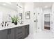 Bathroom featuring dual sinks, a vanity with black hardware, and a large glass shower with a walk in closet at 7130 Summit Pl, Alpharetta, GA 30009