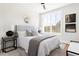 Bright bedroom featuring a large window, stylish decor, and plush bedding with a padded headboard at 7130 Summit Pl, Alpharetta, GA 30009