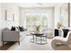 Bright living room with a comfortable sofa, modern decor, and access to an outdoor balcony at 7130 Summit Pl, Alpharetta, GA 30009