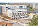 View of the exterior of the modern townhomes featuring a neutral color palette and individual garages at 7130 Summit Pl, Alpharetta, GA 30009