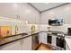 Chic kitchen featuring stainless steel appliances, light cabinetry and stone countertops at 860 Peachtree Ne St # 1513, Atlanta, GA 30308