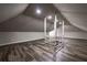 Spacious attic with modern wood flooring, neutral gray paint, and bright recessed lighting at 1029 Katherwood Sw Dr, Atlanta, GA 30310