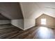 Finished attic featuring new wood flooring, gray walls, and a window for natural light at 1029 Katherwood Sw Dr, Atlanta, GA 30310