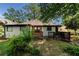 Backyard view of a charming home with mixed siding and a detached garage at 1029 Katherwood Sw Dr, Atlanta, GA 30310