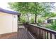 Spacious wooden deck with railing and lush green trees with a view of the two car garage and driveway at 1029 Katherwood Sw Dr, Atlanta, GA 30310