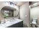 Elegant bathroom featuring a marble countertop, modern mirror, and a separate toilet area at 1029 Katherwood Sw Dr, Atlanta, GA 30310