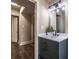 Bathroom featuring modern vanity with matte black fixtures, elegant mirror/lighting fixture and access to hallway at 1029 Katherwood Sw Dr, Atlanta, GA 30310