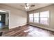 Bedroom with wood-look floors, ceiling fan and a view of the front yard through multiple windows at 1029 Katherwood Sw Dr, Atlanta, GA 30310