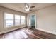 Bright bedroom with beautiful wood-look floors, ceiling fan and a view of the front yard through multiple windows at 1029 Katherwood Sw Dr, Atlanta, GA 30310