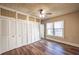Bright bedroom with wood-look floors, a ceiling fan and custom built-in wardrobe at 1029 Katherwood Sw Dr, Atlanta, GA 30310