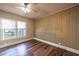 Bedroom featuring unique wallpaper, wood-look floors, and natural light from a window at 1029 Katherwood Sw Dr, Atlanta, GA 30310