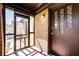 Inviting enclosed front porch with brick accent wall, decorative door and tiled floor at 1029 Katherwood Sw Dr, Atlanta, GA 30310