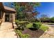 A charming home entrance with a brick facade, complemented by meticulously landscaped flower beds and lush greenery at 1029 Katherwood Sw Dr, Atlanta, GA 30310