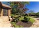 A charming home entrance with a brick facade, complemented by meticulously landscaped flower beds and lush greenery at 1029 Katherwood Sw Dr, Atlanta, GA 30310