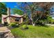 Quaint brick home with landscaped front yard, chimney, and mature shade tree at 1029 Katherwood Sw Dr, Atlanta, GA 30310
