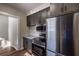 Stainless refrigerator and range with modern gray cabinets, open floor plan and hardwood floors at 1029 Katherwood Sw Dr, Atlanta, GA 30310