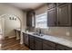 Stainless sink and appliances with sleek gray cabinets, granite counters, and open floor plan at 1029 Katherwood Sw Dr, Atlanta, GA 30310