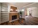 Charming living room with hardwood floors, fireplace with shelving, and arched doorway at 1029 Katherwood Sw Dr, Atlanta, GA 30310