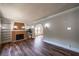 Spacious living room with hardwood floors, fireplace, built-in shelves, and neutral paint at 1029 Katherwood Sw Dr, Atlanta, GA 30310