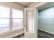 Bright office space featuring wood floors, three windows, and a glass paned door leading to a closet at 1029 Katherwood Sw Dr, Atlanta, GA 30310