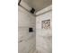 Modern shower with stylish tile work, shower head, and inset shelf at 1029 Katherwood Sw Dr, Atlanta, GA 30310