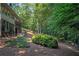 Well-maintained backyard with mature trees and lush landscaping provides privacy at 2080 Old Dominion Rd, Atlanta, GA 30350
