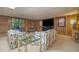 Finished basement featuring retro wood paneling, plush seating, and large-screen television at 2080 Old Dominion Rd, Atlanta, GA 30350