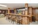 Basement wet bar featuring wood paneling and seating at 2080 Old Dominion Rd, Atlanta, GA 30350
