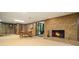 Basement features a brick fireplace, wood paneling, and a small dining table with doorway to exterior at 2080 Old Dominion Rd, Atlanta, GA 30350