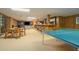 Entertaining basement featuring a ping pong table, dining area, bar, and TV area at 2080 Old Dominion Rd, Atlanta, GA 30350