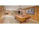 Finished basement game room features wood paneling, billiards table, and brick fireplace at 2080 Old Dominion Rd, Atlanta, GA 30350