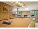 Spacious basement with pool table, brick fireplace, wood paneling, and walkout to the backyard at 2080 Old Dominion Rd, Atlanta, GA 30350