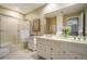 Spacious bathroom with dual sinks, a large mirror, and a glass-enclosed shower at 2080 Old Dominion Rd, Atlanta, GA 30350