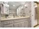 Bathroom with a wallpapered accent wall, a vanity with storage, and a glass shower at 2080 Old Dominion Rd, Atlanta, GA 30350