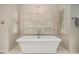 Luxurious bathroom featuring a standalone tub, and natural light from the shuttered windows at 2080 Old Dominion Rd, Atlanta, GA 30350