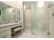 Elegant bathroom featuring a vanity with ample storage, a makeup area, and a large glass enclosed shower at 2080 Old Dominion Rd, Atlanta, GA 30350